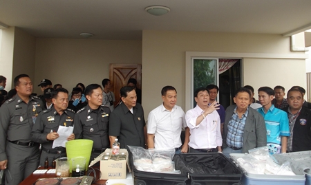 Police put out for display suitcases full of drugs, along with chemicals and drug making equipment during the raid.